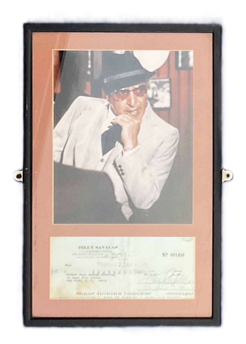 Telly Savalas Signed cheque 15/02/1977, with colour photo. Framed. Measures 11 inch by 16-inch appx.