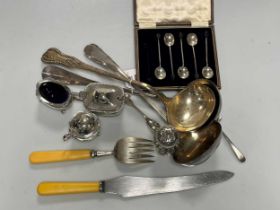 Some silver cruets, two sets of silver and mother of pearl cutlery and some cased silver bean end