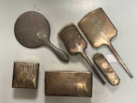 A small collection of silver including two cigarette boxes, two silver backed hand mirrors, a silver