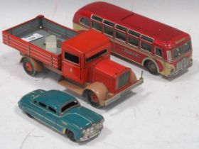 Three vintage Tippco tinplate models of a flatbed truck, a bus and a car