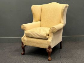 George II style cream upholsted wing back armchair on ball and claw feet