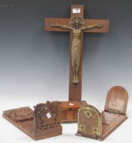 An oak backed bronze crucifix, 56cm high; a walnut and brass mounted book slide, a carved book slide