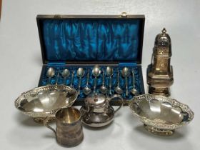 A collection of silverware including christening mug, caster, bon bon dishes and mustard, along with