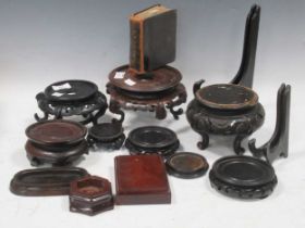 A quantity of Chinese wooden stands for bowls and vases