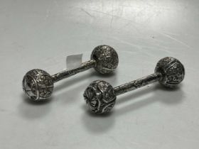 A pair of continental metalwares dumbbell style rattles, apparently unmarked, tests as silver, 45.5g