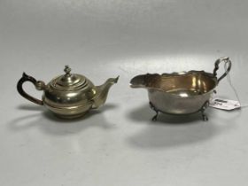 A silver sauceboat, together with a continental metalwares (possibly) saffron pot (2)