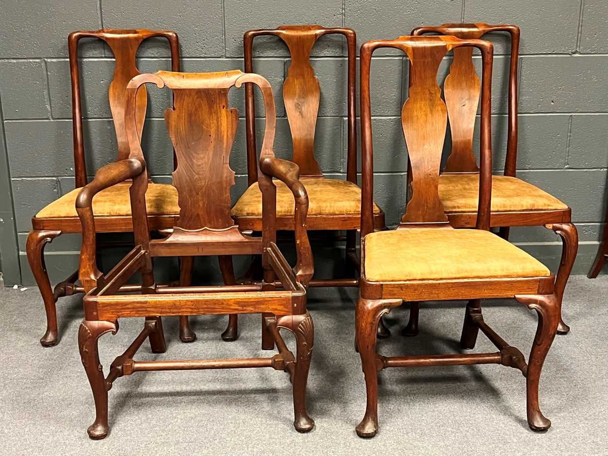 A set of four Queen Anne style walnut dining chairs, with vase shaped