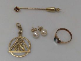 A pendant stamped ‘585’, a ring stamped ‘585’, gross weight 8.5g, together with a stick pin,