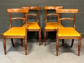 A late Georgian mahogany oval drop flap dining table with double gate legs, 121 x 163cm, and a set