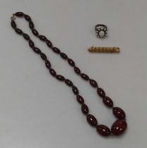 A bakelite bead necklace weight 28.8g, together with a brooch stamped '9CT' weight 4.2g, and an opal