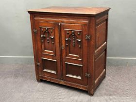 An 18th century oak cupboard with pair of panelled doors to the front, one side frieze drawer, on