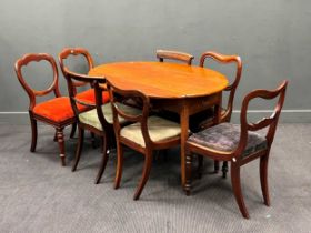 An oval mahogany drop flap table, the top 120 x 90cm, and seven various Victorian dining chairs