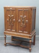 An oak two door cupboard with geometric moulded front 111 x 76 x 43