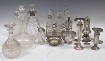 A collection of silverware including caster, 2 bowls, loaded vases, 4 decanter labels and