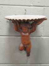 A carved cherub bracket, 33 x 30 x 21cm