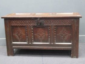 An 18th century oak panelled coffer chest with S acanthus scrolled frieze and triple lozenge panel