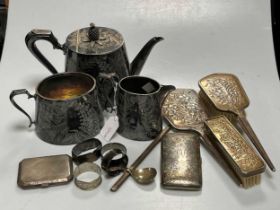 Four silver napkin rings, a silver caddy spoon and two silver cigarette cases, 304g (9.7ozt)