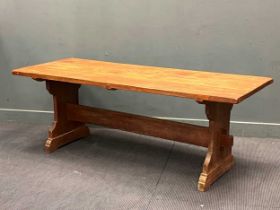 A three plank refectory table on shaped ends and trestle base, 198 x 75cm