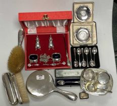 A collection of silverware including a cased cruet, dressing table items, cased flatware, vesta, tea