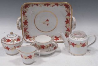 A Coalport solitaire set, circa 1805, painted with a band of iron red flowers, comprising a two-