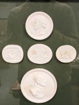 A modern framed group of five plaster cast medallions of portraits and classical subjects; with