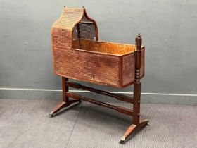 A Regency mahogany caned rocking cradle on turned supports 127 x 104 x 56cm