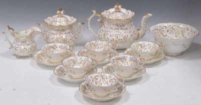 A Rockingham tea and coffee service, circa 1835, with gilded scrolls and leaves on a white ground,