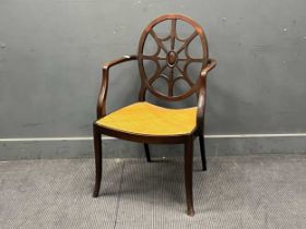 An 18th century style mahogany oval back armchair with saddle caned seat, the back with central oval