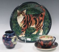 A Moorcroft cup and saucer, a small vase and modern cat decorated plate (4)