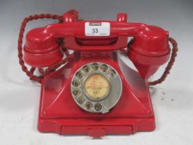 Vintage red bakelite case telephone with drawer, marked to underside '1/232F S56/2', handset