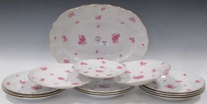 A Herend part dinner service, with newozier moulded borders, painted in puce with scattered flower