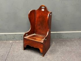 A 19th century mahogany porter's style chair made for a child, with lift up seat for a commode. 66cm