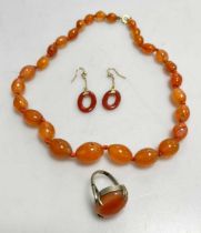 A pair of cornelian earrings, together with a cornelian bead necklace and ring (3)