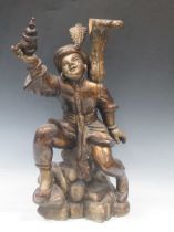 An Eastern carved wood figure 62cm high