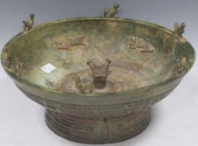 A Chinese bronze divination bowl, the rim surmounted with bird decoration, the interior with fish
