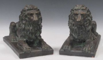 A pair of bronzed terracotta models of recumbent lions. 26cm H x 37cm W x 20cm D