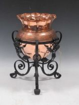 An Arts & Crafts copper jardiniere on metal stand 39 x 25cm