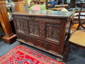 A large 17th century oak coffer with carved panel front, 77 x 123 x 52 cm.