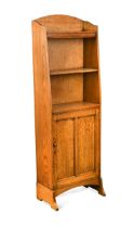 An Arts & Crafts oak narrow bookcase cabinet, circa 1910,