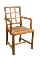 A Heal's oak lattice back elbow or desk chair,