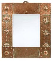 J & F Pool of Hayle, an Arts & Crafts hammered copper and bevelled glass wall mirror,