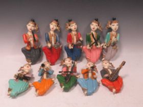 A group of 10 painted wooden musical wall-mounted figures, probably Thai or Burmese, each about 25cm