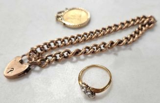 A sovereign in a 9ct gold pendant and a curb bracelet marked 9c, 34.6g gross, along with a diamond
