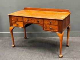 A George III style walnut dressing table on cabriole legs. 83cm x 122cm x 61cm