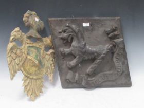 A wooden painted and carved coat of arms of double headed eagle with knight's helmet 54 x 36cm,