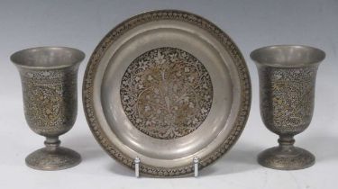 A pair of niello decorated and engraved Islamic metalware goblets and matching dish. Goblets 14cm