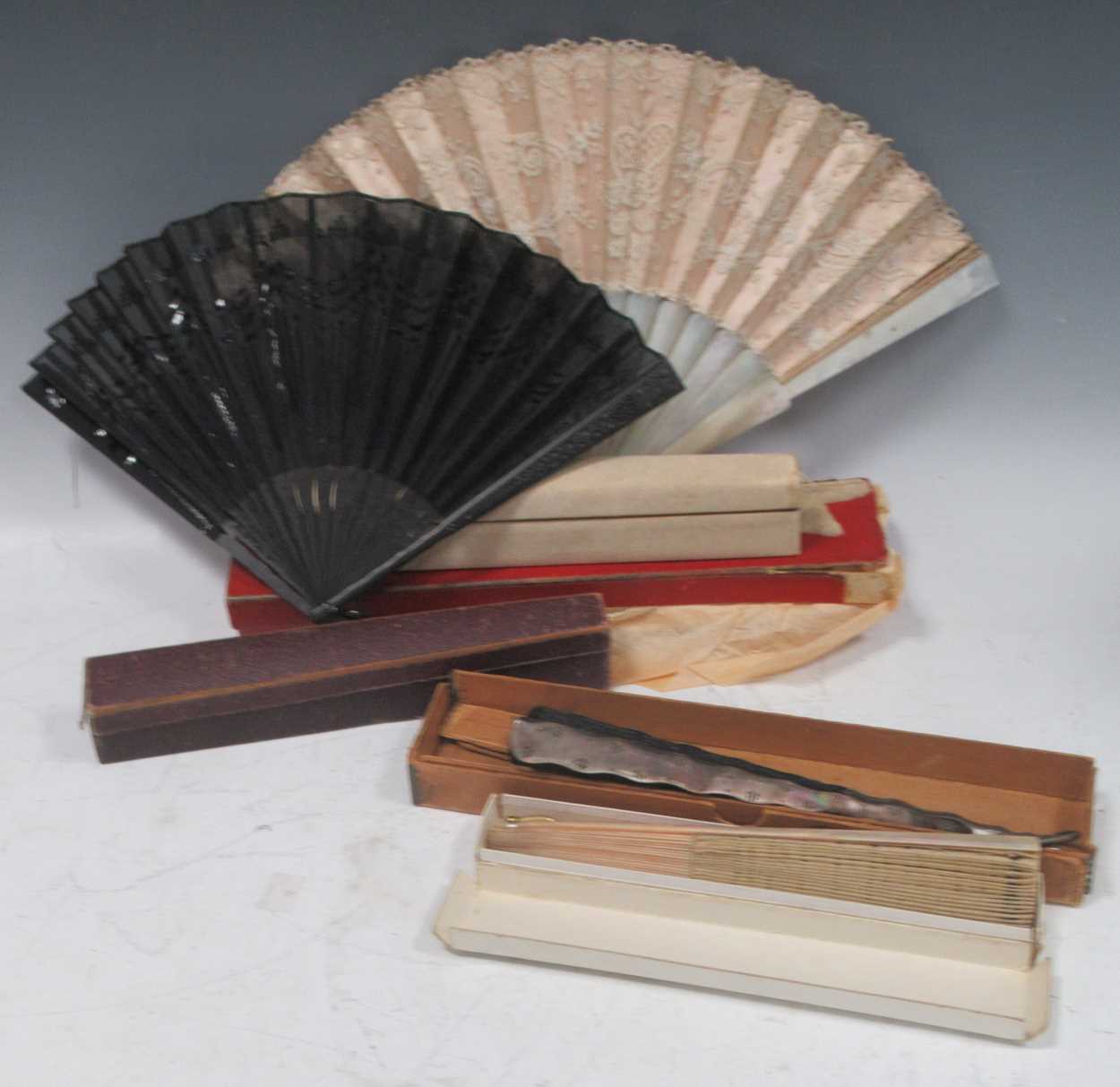 Seven fans to include a Venetian bone example inset with a mirror, one with feathers, three mother