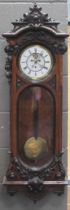 A walnut Vienna wall clock, with carved swag decorated case, two part dial with single weight