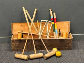 A 20th century croquet set in a pine box, matched set of 6 mallets, 7 wooden balls, 2 pins, 6 hoops.