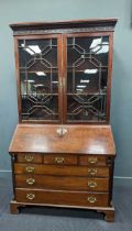 A George III style 19th century mahogany bureau bookcase, the glazing with unusual x design, the